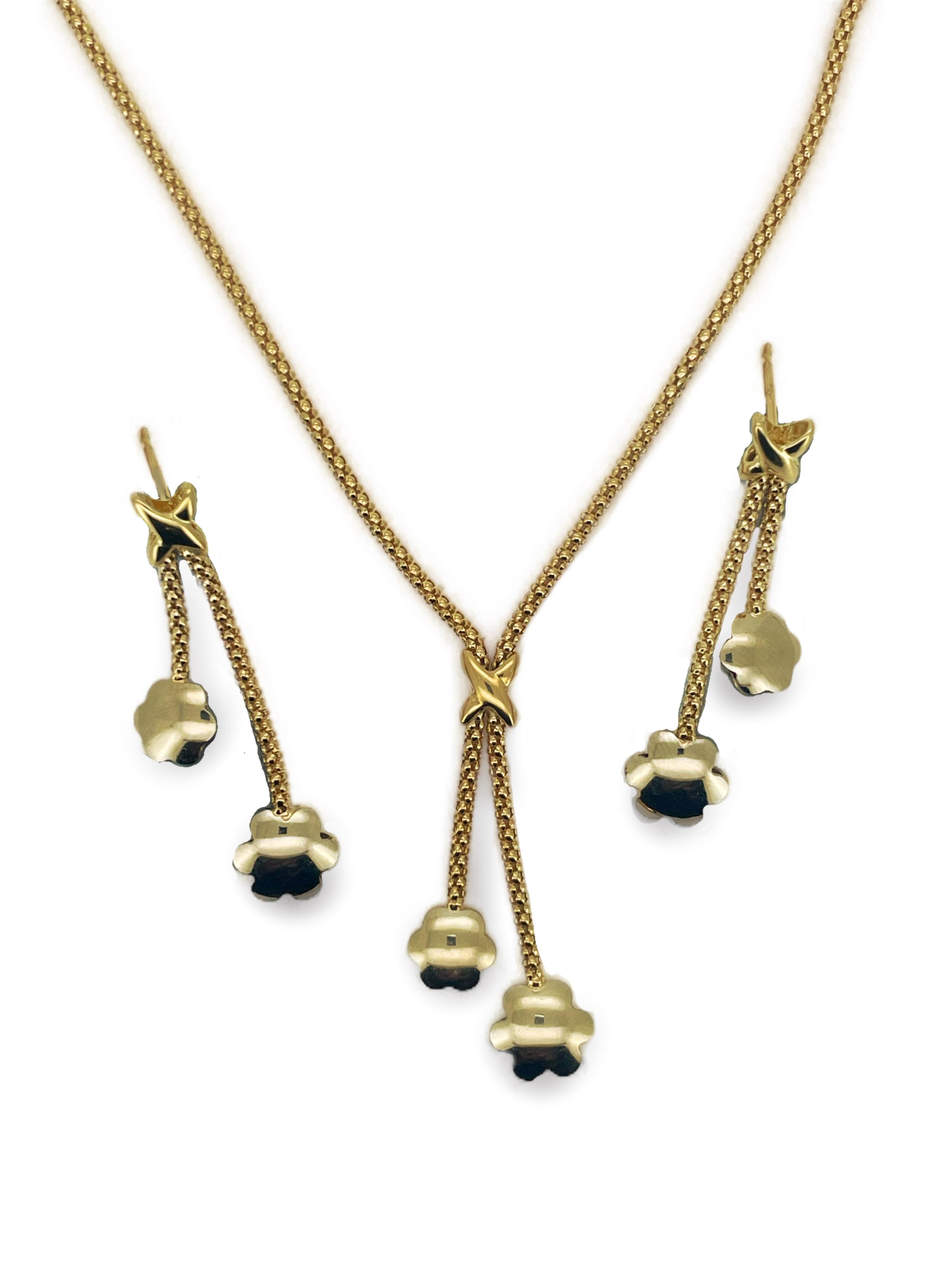 A modern yellow metal, stamped 750, necklace with two flowerhead tassel drops, overall approx. 47cm and a pair of matching drop earrings(lacking butterflies), 10 grams.